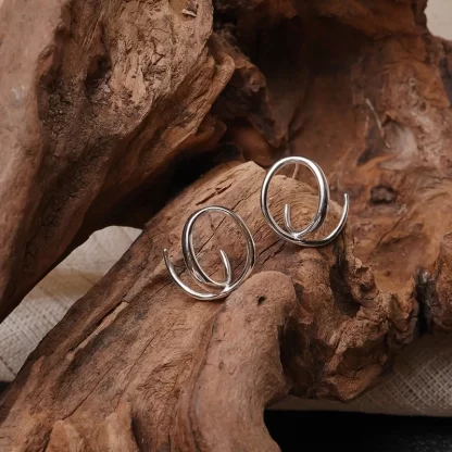 silver earrings swirl